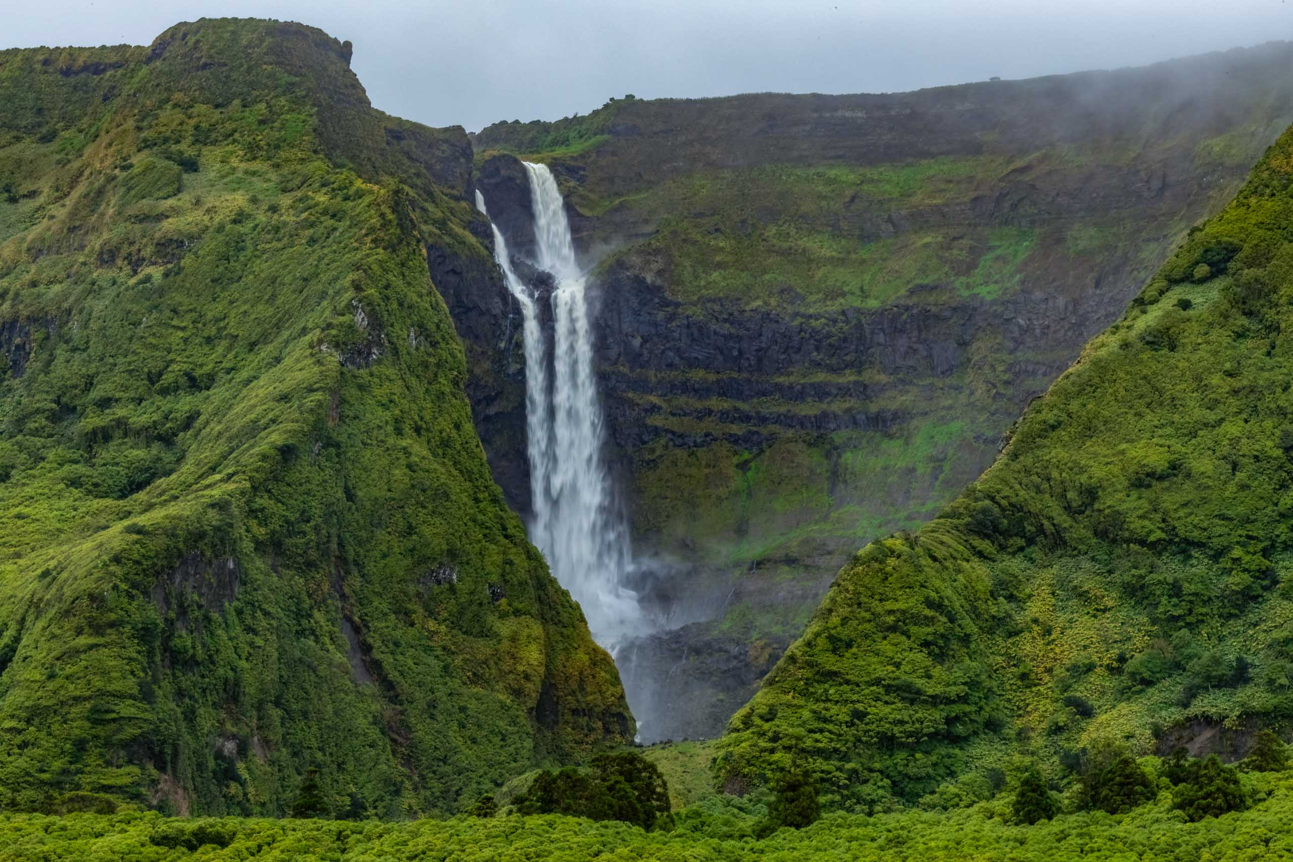 Breathtaking view of waterfall in the green mountains on Flores island Azores Portugal